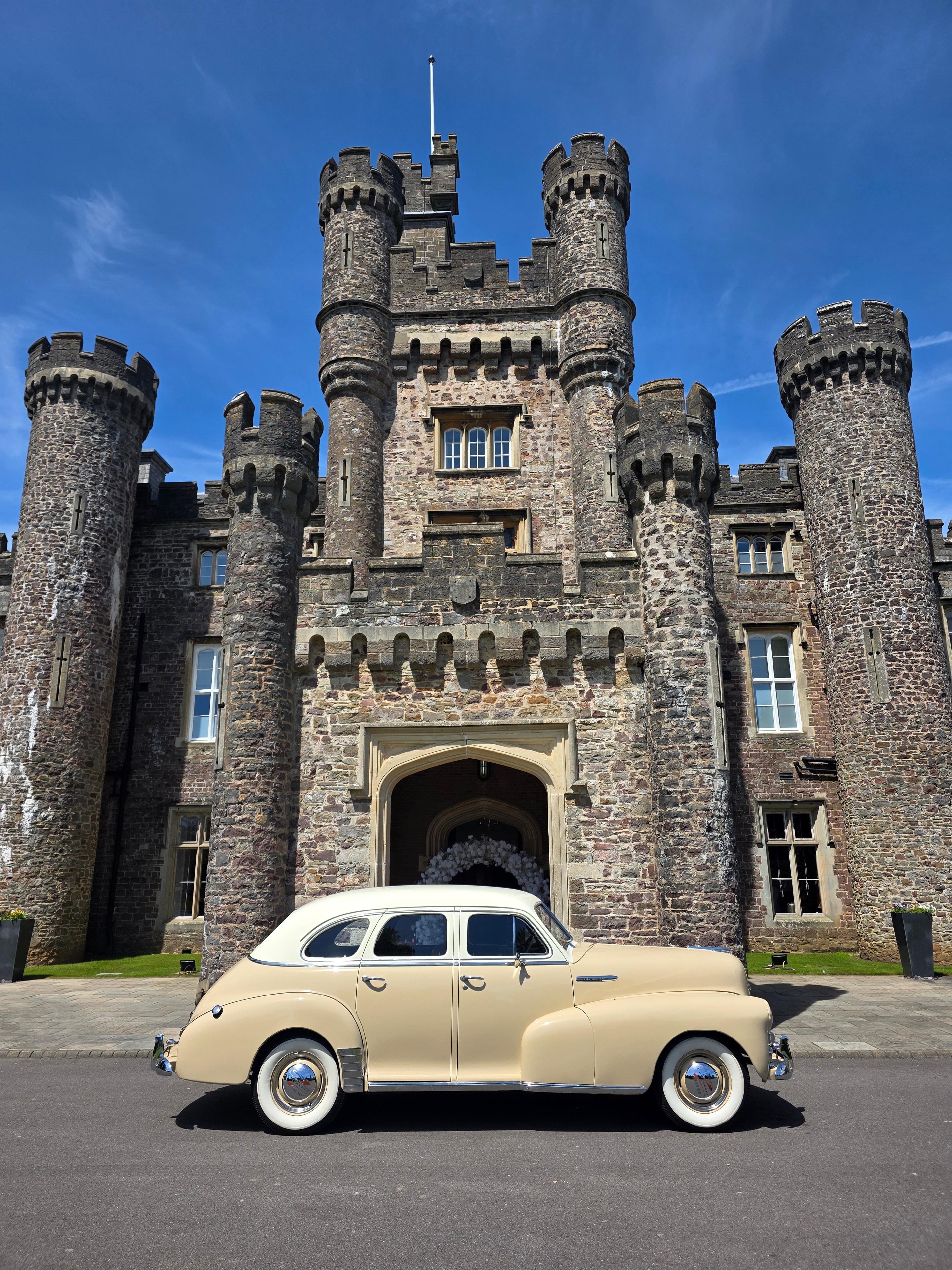 Vintage wedding car on a scenic countryside road