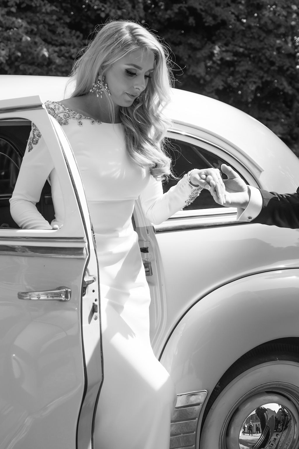 Bride stepping out of a vintage wedding car